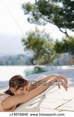 Woman relaxing by a pool. View Large Photo Image Stock Photo - Woman relaxing by a pool.. Fotosearch