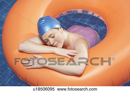 Woman resting in rubber ring. View Large Photo Image Stock Photography - Woman resting in rubber ring.. Fotosearch
