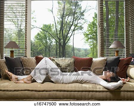 Woman sleeping on sofa in living room. View Large Photo Image Stock Image - Woman sleeping on sofa in living room.. Fotosearch