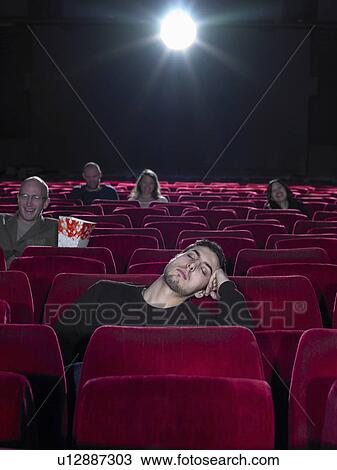 Young man asleep in cinema View Large Photo Image Stock Image - Young man asleep in cinema. Fotosearch