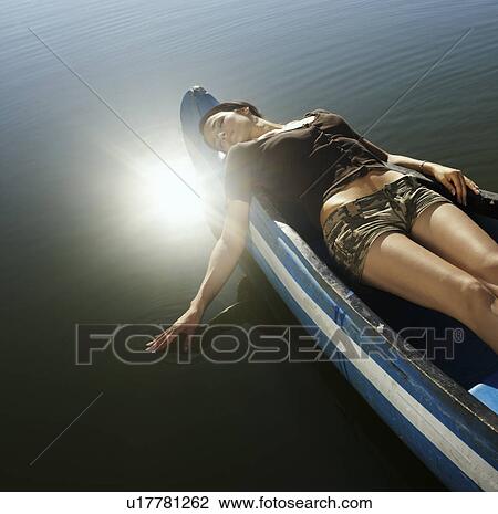 Young woman asleep in Canoe. View Large Photo Image Stock Image - Young woman asleep in Canoe.. Fotosearch