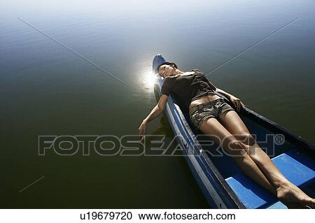 Young woman asleep in Canoe. View Large Photo Image Stock Image - Young woman asleep in Canoe.. Fotosearch