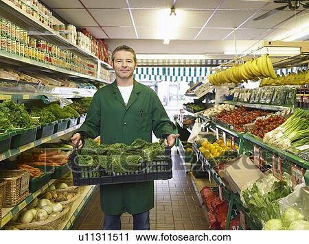 Grocer carrying some fresh vegetables View Large Photo Image Stock Image - Grocer carrying some fresh vegetables. Fotosearch