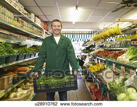 Grocer carrying some fresh vegetables View Large Photo Image Stock Image - Grocer carrying some fresh vegetables. Fotosearch
