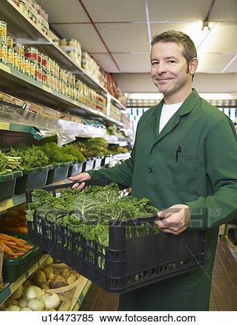 Grocer carrying some fresh vegetables View Large Photo Image Stock Photography - Grocer carrying some fresh vegetables. Fotosearch