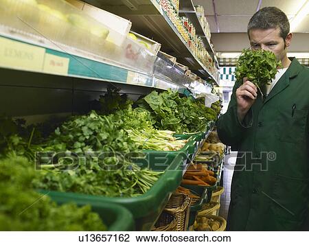 Grocer smelling herbs View Large Photo Image Stock Image - Grocer smelling herbs. Fotosearch
