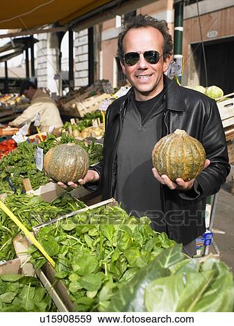 Man choosing vegetables at Rialto market. Venice, Italy. View Large Photo Image Stock Photo - Man choosing vegetables at Rialto market. Venice, Italy.. Fotosearch