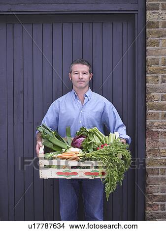 Man with a crate of vegetables View Large Photo Image Picture - Man with a crate of vegetables . Fotosearch