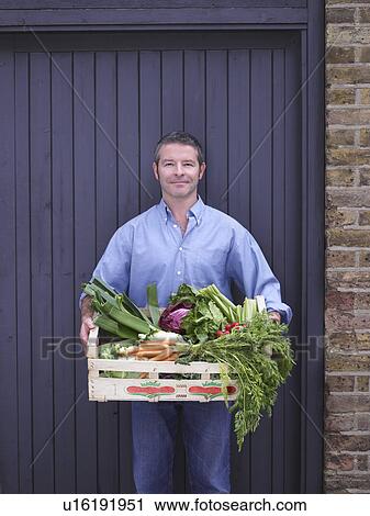 Man with a crate of vegetables View Large Photo Image Stock Image - Man with a crate of vegetables . Fotosearch