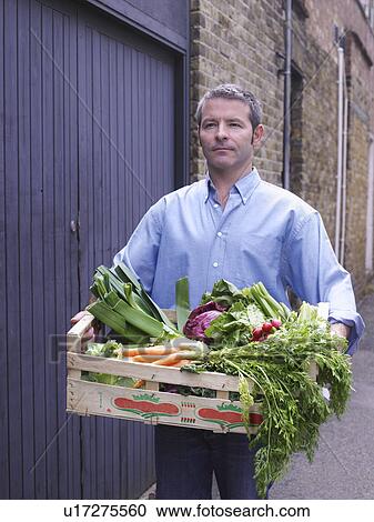 Man with a crate of vegetables View Large Photo Image Stock Image - Man with a crate of vegetables . Fotosearch