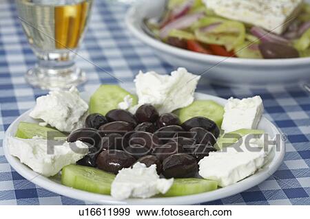 Plate with olives feta and cucumber on table Greek salad and retsina in background. View Large Photo Image Stock Photo - Plate with olives feta and cucumber on table Greek salad and retsina in background.. Fotosearch