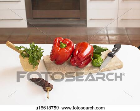 Red peppers and chillies with knife on chopping board View Large Photo Image Stock Photo - Red peppers and chillies with knife on chopping board. Fotosearch