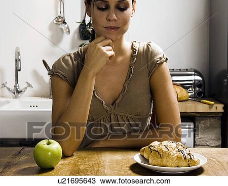 Woman at table with apple and pastry. View Large Photo Image Stock Image - Woman at table with apple and pastry.. Fotosearch