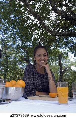 Young woman with oranges and orange juice View Large Photo Image Stock Photo - Young woman with oranges and orange juice. Fotosearch