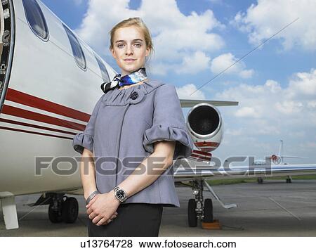 Flight attendant next to private jet. View Large Photo Image Stock Photo - Flight attendant next to private jet.. Fotosearch