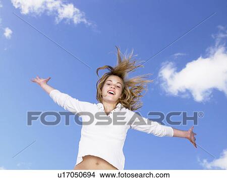 Girl jumping in the air. View Large Photo Image Picture - Girl jumping in the air.. Fotosearch