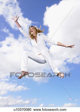 Girl jumping in the air. View Large Photo Image Stock Image - Girl jumping in the air.. Fotosearch