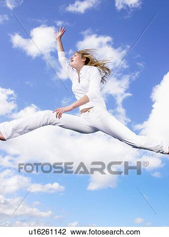 Girl jumping in the air. View Large Photo Image Stock Image - Girl jumping in the air.. Fotosearch
