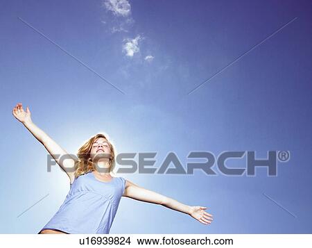 Picture - Girl with arms wide open.. Fotosearch