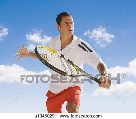 Man playing tennis against blue sky. View Large Photo Image Stock Image - Man playing tennis against blue sky.. Fotosearch