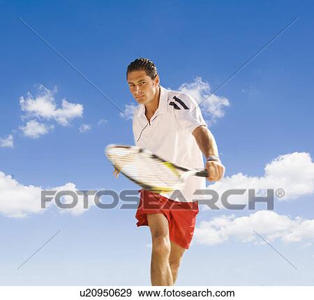 Man playing tennis against blue sky. View Large Photo Image Stock Photo - Man playing tennis against blue sky.. Fotosearch