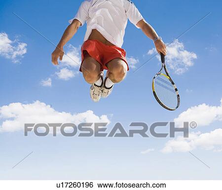 Man playing tennis against blue sky. View Large Photo Image Stock Photograph - Man playing tennis against blue sky.. Fotosearch