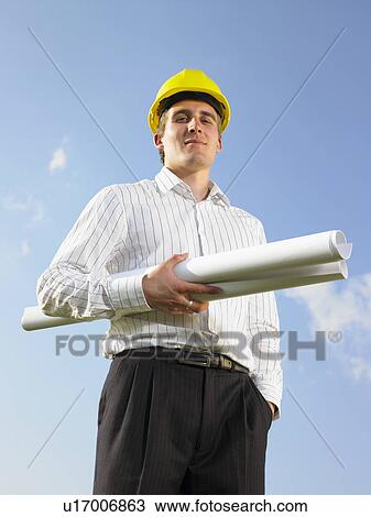 Stock Image - Surveyor in front of blue skies.. Fotosearch