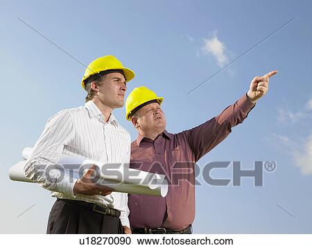 Stock Image - Surveyors on a field.. Fotosearch