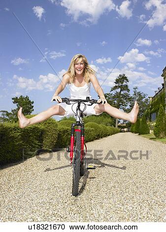 Woman playing on her bicycle. View Large Photo Image Stock Image - Woman playing on her bicycle.. Fotosearch