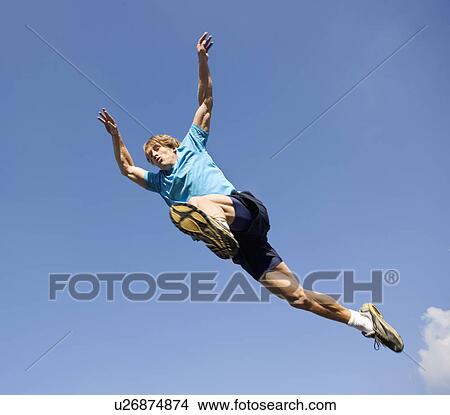 Young man jumping in sports kit. View Large Photo Image Picture - Young man jumping in sports kit.. Fotosearch