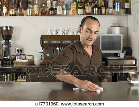 Barista polishing the counter in café. Alicante, Spain. View Large Photo Image Stock Image - Barista polishing the counter in café. Alicante, Spain.. Fotosearch