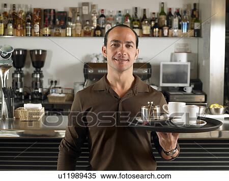 Barista with tray of coffee cups by counter in café. Alicante, Spain. View Large Photo Image Stock Photography - Barista with tray of coffee cups by counter in café. Alicante, Spain.. Fotosearch