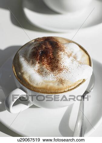 Cappuccino on table, close-up View Large Photo Image Stock Photo - Cappuccino on table, close-up. Fotosearch
