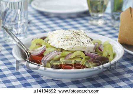 Greek salad on table glasses and plate in background. View Large Photo Image Stock Image - Greek salad on table glasses and plate in background.. Fotosearch