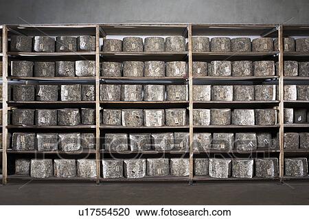 Wall of cheeses sitting on racks. View Large Photo Image Stock Image - Wall of cheeses sitting on racks.. Fotosearch