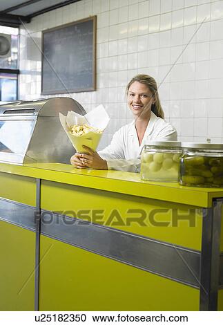 Young woman serving in fish and chip shop, smiling, portrait View Large Photo Image Stock Image - Young woman serving in fish and chip shop, smiling, portrait. Fotosearch