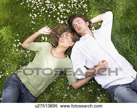 Couple sleeping in the grass. View Large Photo Image Stock Photography - Couple sleeping in the grass.. Fotosearch