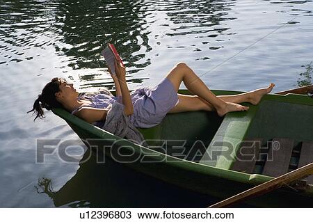 Woman reading a book in boat View Large Photo Image Stock Image - Woman reading a book in boat. Fotosearch
