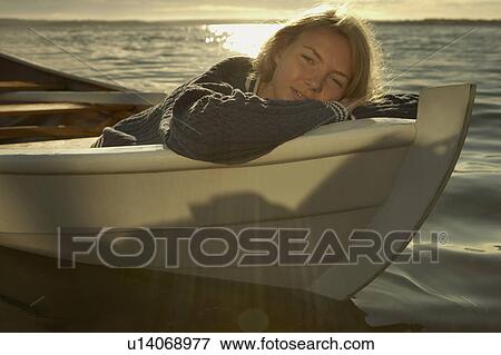 Stock Photo - Young woman in rowing boat.. Fotosearch