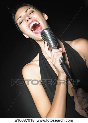Female singer with microphone elegant black dress portrait. View Large Photo Image Stock Photo - Female singer with microphone elegant black dress portrait.. Fotosearch