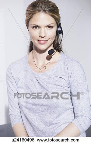 Stock Photograph - Woman with telephone headset smiling.. Fotosearch