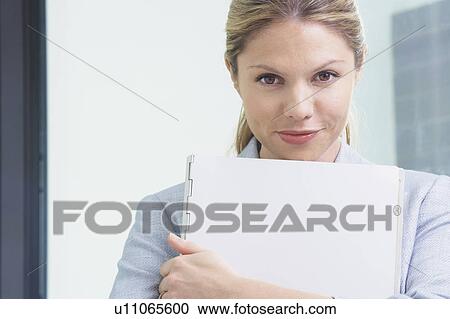 Young Business woman in office with file smiling. View Large Photo Image Stock Image - Young Business woman in office with file smiling.. Fotosearch