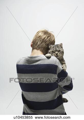Boy holding a cat View Large Photo Image Stock Photography - Boy holding a cat. Fotosearch
