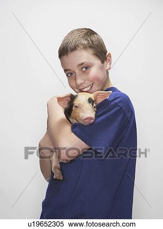 Boy holding piglet View Large Photo Image Stock Photography - Boy holding piglet. Fotosearch