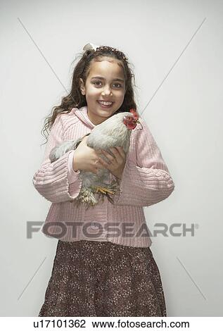 Stock Image - Girl holding hen. Fotosearch