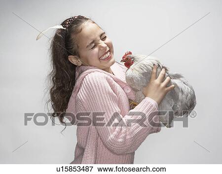 Girl laughing at hen View Large Photo Image Stock Photo - Girl laughing at hen. Fotosearch