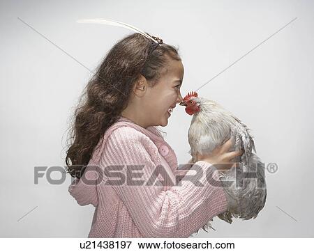 Girl looking at hen View Large Photo Image Stock Photo - Girl looking at hen. Fotosearch