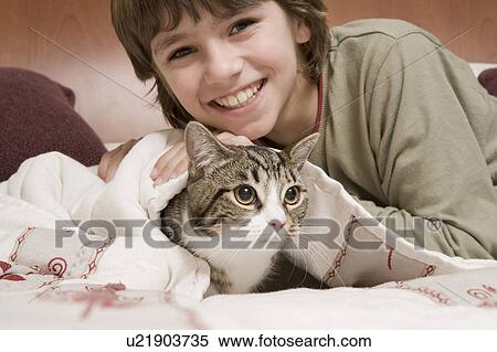 Stock Photography - Young boy with pet cat. Fotosearch