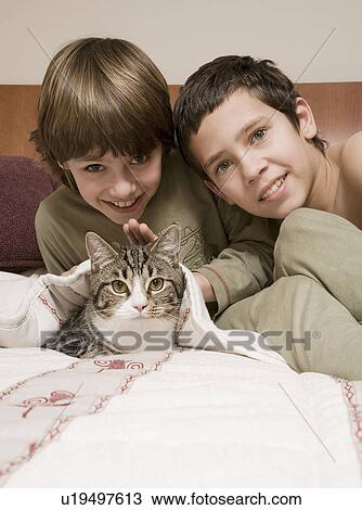 Young boys with pet cat View Large Photo Image Stock Image - Young boys with pet cat. Fotosearch