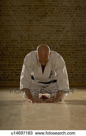 Karate man bowing. Stock Image | u14697183 | Fotosearch